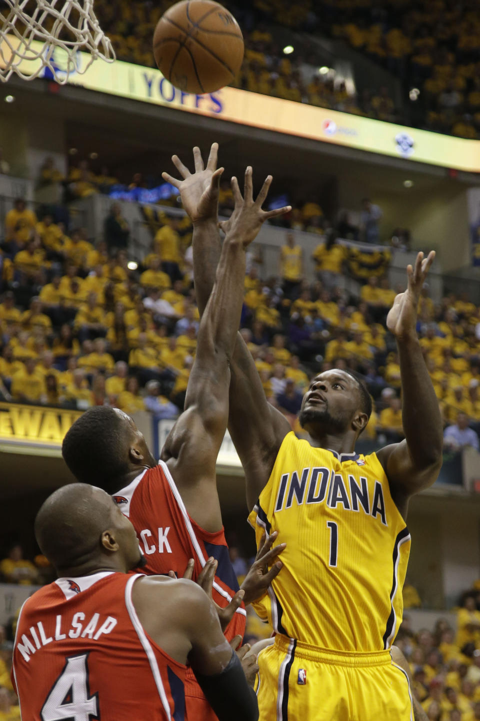 Indiana Pacers guard Lance Stephenson (1) shoots over Atlanta Hawks defenders Shelvin Mack and Paul Millsap (4) in the second half during Game 7 of a first-round NBA basketball playoff series in Indianapolis, Saturday, May 3, 2014. The Pacers won 92-80. (AP Photo/AJ Mast)