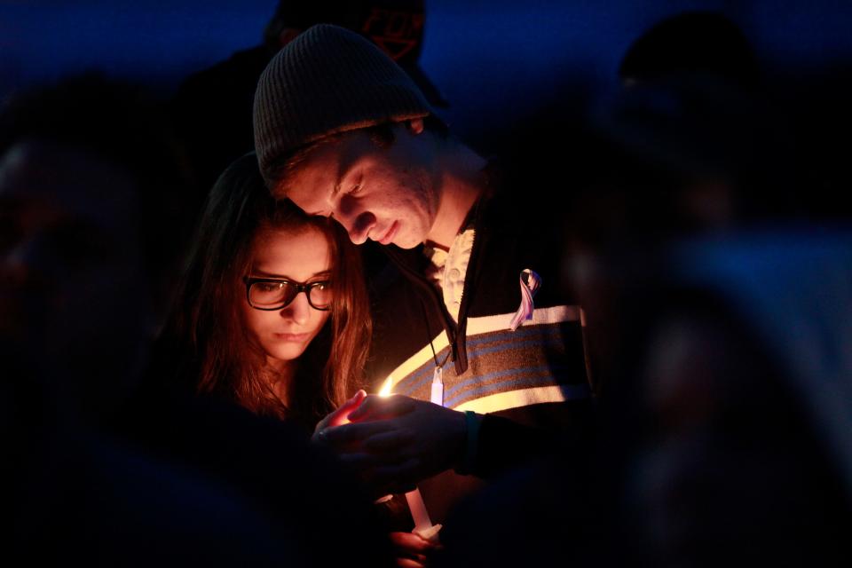 Kaetlyn Dyer and Kellis Kincaid comfort one another during a candle light vigil at Kings Mills High School to remember the life of Leelah Alcorn, a 17 year-old transgender girl, who committed suicide last week, in Kings Mills, Ohio Saturday, January 3, 2015.