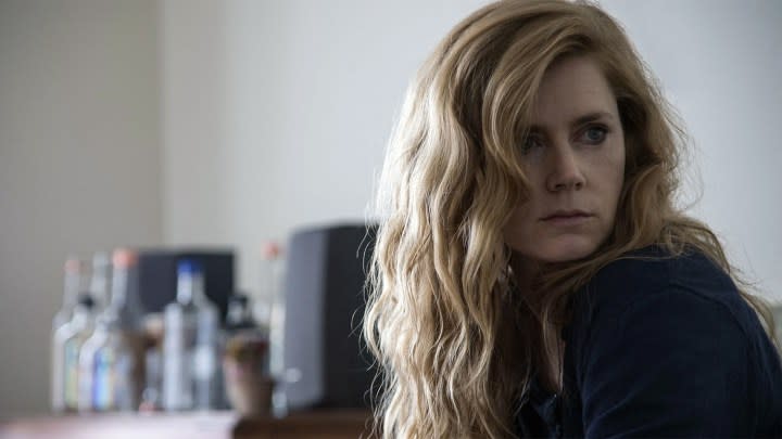 Amy Adams as Camille Preaker looking behind her in Sharp Objects.