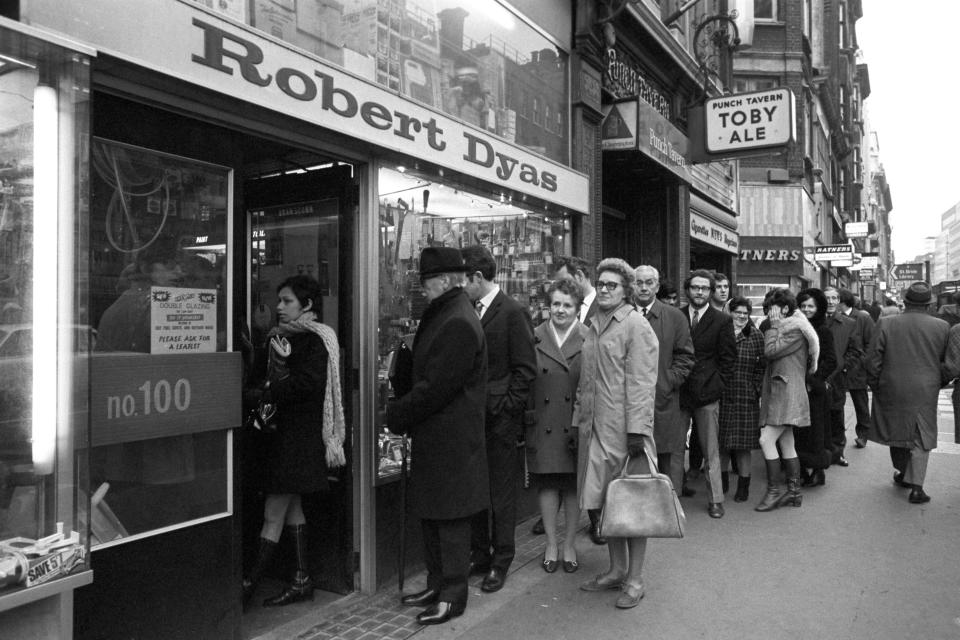 Members of the public, anticipating power cuts, patiently queue outside a Fleet Street shop this morning to purchase candles.   (Photo by PA Images via Getty Images)