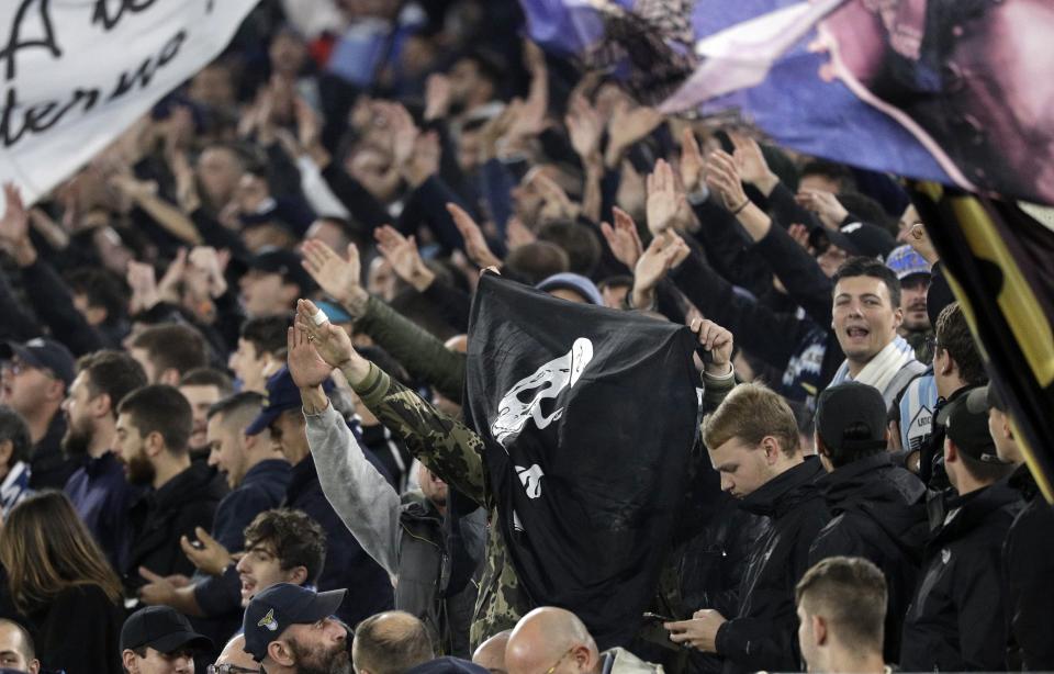 FILE - A group of Lazio fans make the fascist salute ahead of an Europa League group E soccer match between Lazio and Celtic, in Rome's Olympic Stadium, Thursday, Nov. 7, 2019. Among the thousands of fans in the stands at Europe's biggest soccer games are a few people operating undercover. Trained volunteer observers listen for racist chants and watch for extremist symbols on banners. (AP Photo/Gregorio Borgia, File)