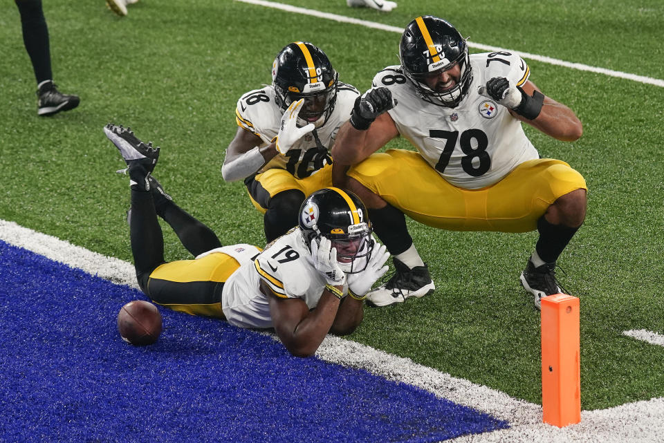 Pittsburgh Steelers wide receiver JuJu Smith-Schuster (19) offensive tackle Alejandro Villanueva (78) and wide receiver Diontae Johnson (18) celebrate after Smith-Schuster scored a touchdown against the New York Giants during the fourth quarter of an NFL football game Monday, Sept. 14, 2020, in East Rutherford, N.J. (AP Photo/Seth Wenig)
