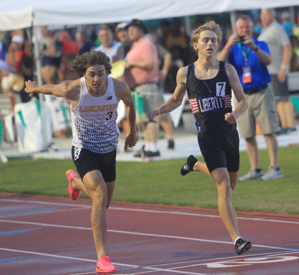 Lancaster's Colton Thress attempts to lean past Olentangy Liberty's Jaxson Eckert at the finish line of the Division I boys 800 during the state meet Saturday. Eckert edged Thress for the title.