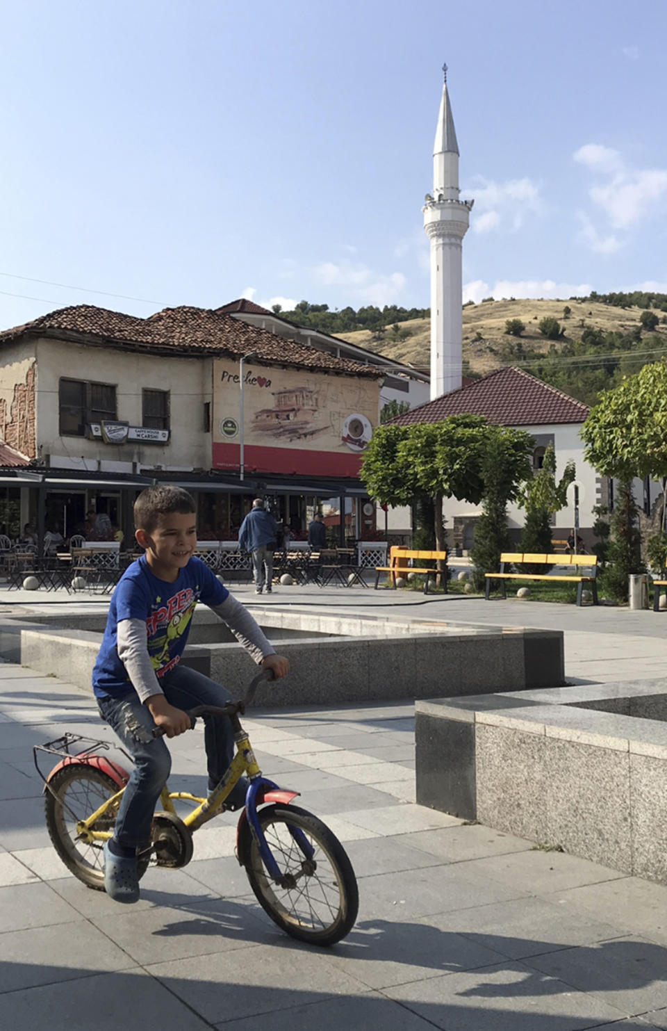 A boy riding bicycle on street in the town of Presevo, Serbia, Thursday, Sept. 6, 2018, which could become part of a land swap deal to reach a lasting solution for the decades-long dispute between Serbia and Kosovo. The idea that the two former war foes Serbia and Kosovo could exchange territories has been floated in recent weeks by officials and media on both sides of this divided region. (AP Photo/Zenel Zhinipotoku)