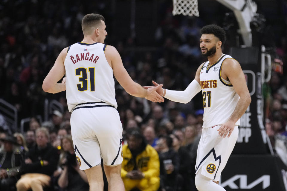 Denver Nuggets guard Jamal Murray (27) celebrates with forward Vlatko Cancar (31) after scoring during the second half of the team's NBA basketball game against the Los Angeles Clippers on Friday, Jan. 13, 2023, in Los Angeles. (AP Photo/Marcio Jose Sanchez)
