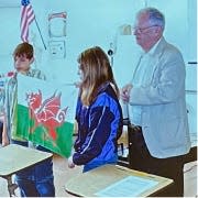 Eilrug Davies, professor of Welsh literature at Harvard University, presented students at Briceville Elementary School with a flag of Wales.