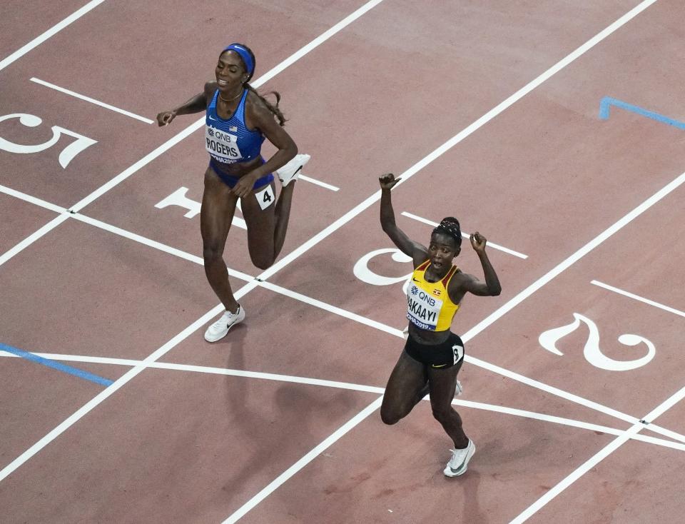 Halimah Nakaayi, of Uganda, reacts in front of Raevyn Rogers, of the United States, as she wins the women's 800 meter final at the World Athletics Championships in Doha, Qatar, Monday, Sept. 30, 2019. (AP Photo/Morry Gash)