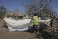 In this photo released by the Tonga Red Cross Society, Red Cross teams set up a temporary shelter in Kanokupolu, western Tongatapu, Friday, Jan. 21, 2022, as the Tonga island group grapples with the aftermath from the recent underwater volcanic eruption. (Tonga Red Cross Society via AP)