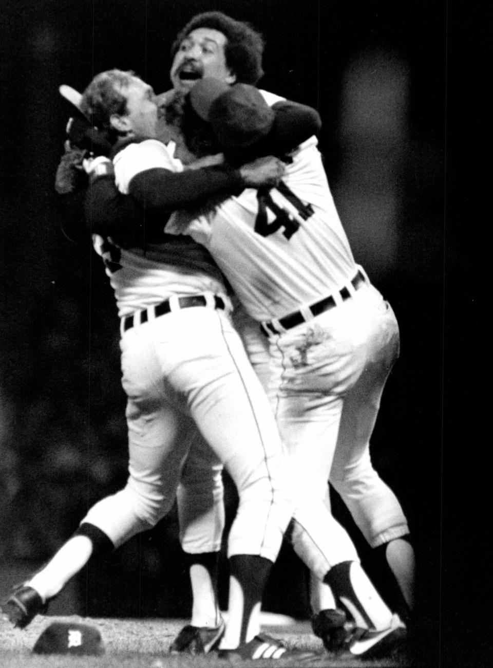 Willie Hernandez, center, embraces Darrell Evans, right, and Alan Trammell after the Tigers took the AL flag in 1984 at Tiger Stadium.