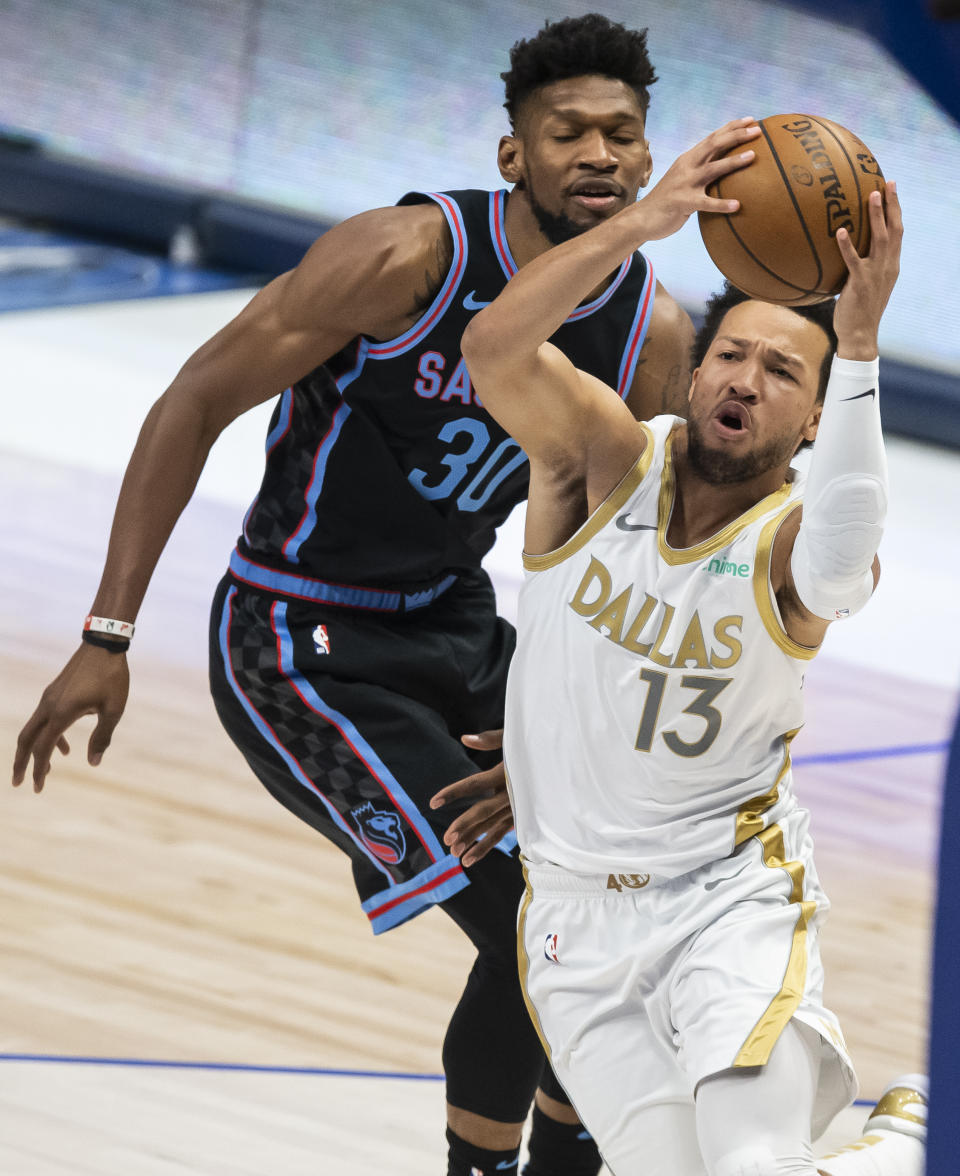 Dallas Mavericks guard Jalen Brunson (13) battles past Sacramento Kings forward Chris Silva (30) during the half of an NBA basketball game, Sunday, April 18, 2021, in Dallas. (AP Photo/Brandon Wade)