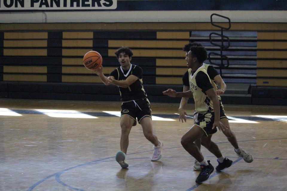 Milton's Javier Valarezo (1) passes the ball during a drill in the Panthers' boys basketball practice on Monday, Dec. 18, 2023.