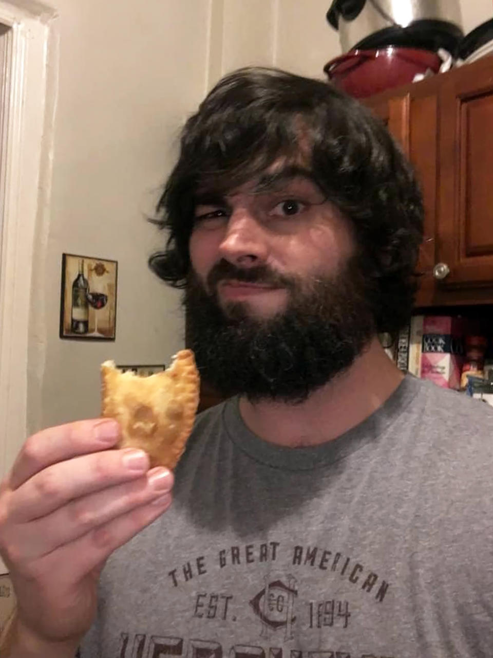 My partner snacking on a homemade empanada. (Courtesy Danielle Campoamor)