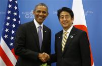 U.S. President Barack Obama (L) shakes hands with Japanese Prime Minister Shinzo Abe at the G20 Summit in St. Petersburg, Russia September 5, 2013. REUTERS/Kevin Lamarque
