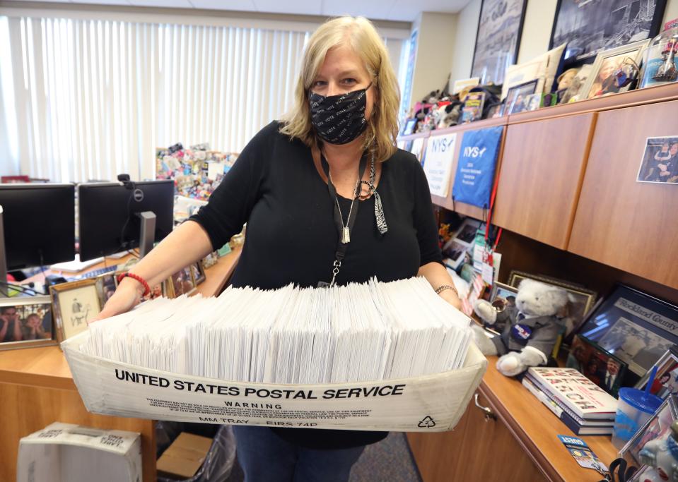 Kristen Zebrowski, Democratic  commissioner carries a tray of absentee ballots to be sorted at the Rockland Board of Elections in New City Nov. 4, 2020.