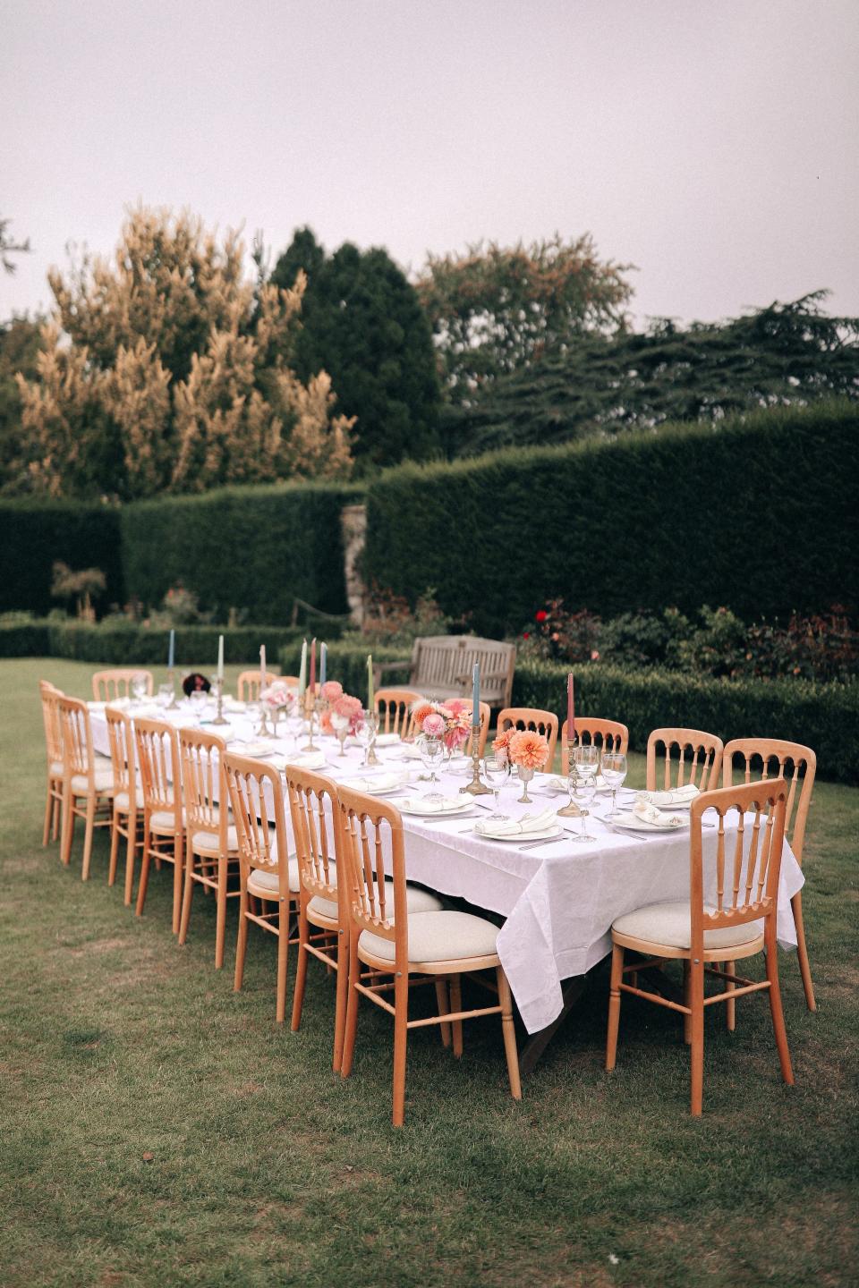 A table is set for a wedding in a garden.