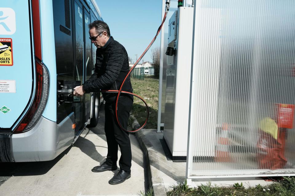 Maintenance manager at French transport company Transdev, David Carronnier, fills a bus tank with diesel at a bus terminal in Lieusaint, south of Paris, Monday, March 21, 2022. European governments are slashing fuel taxes and doling out tens of billions to help consumers, truckers, farmers and others cope with spiking energy prices made worse by Russia’s invasion of Ukraine. (AP Photo/Thibault Camus)