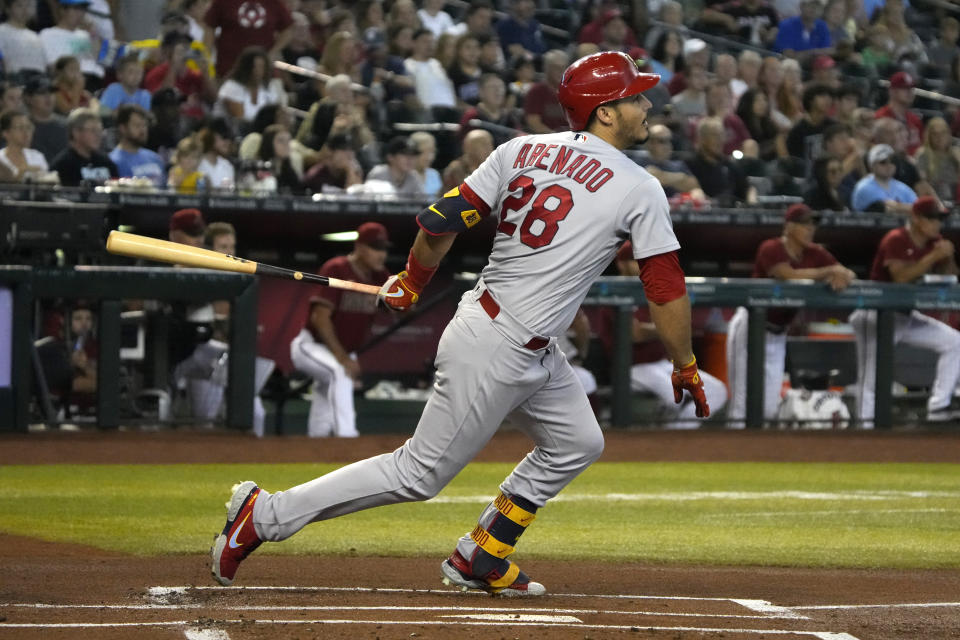 St. Louis Cardinals' Nolan Arenado hits an RBI-single against the Arizona Diamondbacks in the first inning during a baseball game, Sunday, Aug. 21, 2022, in Phoenix. (AP Photo/Rick Scuteri)