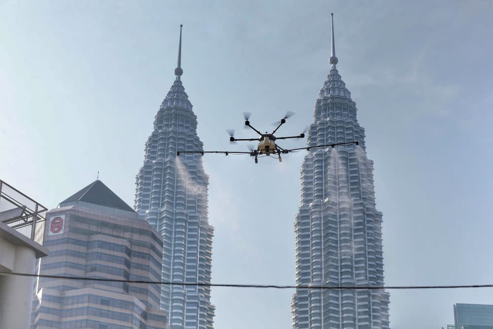 A drone is used to spray disinfectant in Kampung Baru to curb spread of Covid-19 in Kuala Lumpur March 31, 2020. — Picture by Ahmad Zamzahuri