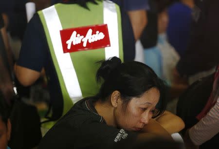 A family member of a passenger onboard the missing AirAsia flight QZ8501 react as waiting news at a waiting area in Juanda International Airport, Surabaya December 29, 2014. REUTERS/Beawiharta