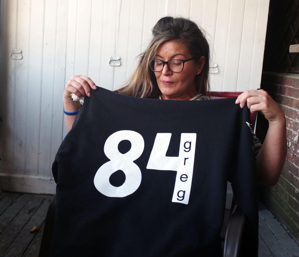 Anastasia Grantsis of Bridgewater, sister of Greg Grantsis, who was shot to death on Nov. 9, 2021 in Brockton, holds up hoodie sweatshirt in honor of her brother at Joe Angelo's in Brockton on Friday, Sept. 22, 2023.