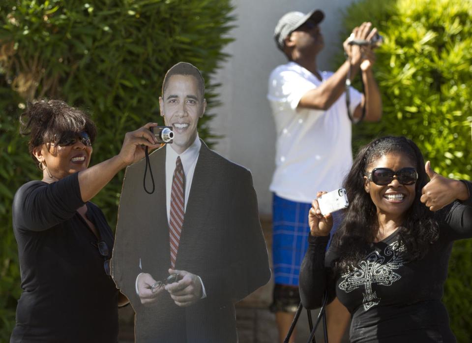 Supporters with a life sized cardboard cutout of President Barack Obama line the streets in View Park where he is participating in a fundraiser, Thursday, June 7, 2012, in Los Angeles. (AP Photo/Carolyn Kaster)