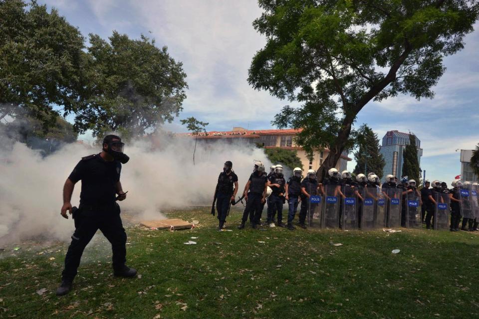 FILE - In this May 28, 2013, file photo, riot police use pepper gas to disperse demonstrators protesting against the cutting down of trees in the center of Taksim Square in Istanbul, Turkey. During the height of Turkey's summer of upheaval, more than a dozen Turkish doctors interviewed by The Associated Press say authorities assaulted them with tear gas, pressured them to reveal the names of patients and ignored calls for resources. (AP Photo/Emrah Gurel, File)