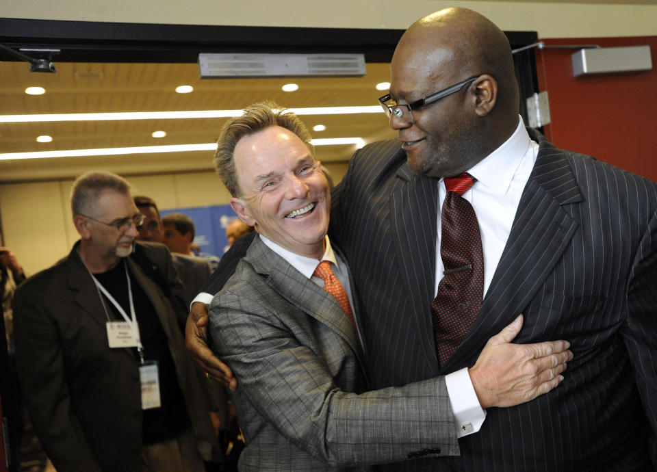 FILE - In this Tuesday, June 10, 2014 file photo, the Rev. Ronnie Floyd, center, of Cross Church in northwest Arkansas, hugs the Rev. Dwight McKissic, right, of Cornerstone Baptist Church in Arlington, Texas, after Floyd was elected the new president of the Southern Baptist Convention during its annual meeting in Baltimore. Ahead of the June 2021 meeting, Asian American and Hispanic participation increased, prompting Floyd to hail America’s diversity as “an amazing opportunity" for future growth. (AP Photo/Steve Ruark)