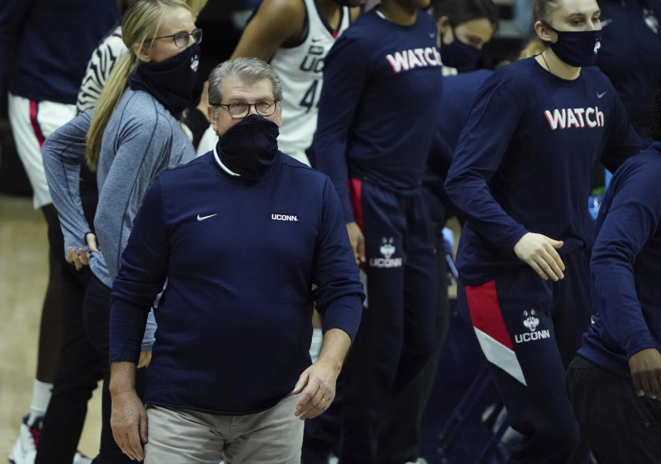 Connecticut coach Geno Auriemma checks the board during a break in play in the first half of the team's NCAA college basketball game against St. John's on Wednesday, Feb. 3, 2021, in Storrs, Conn. (David Butler II/Pool Photo via AP)