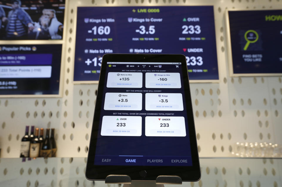 FILE - An iPad displays the types of free bets that could be placed at the Golden 1 Center's Skyloft Predictive Gaming Lounge in Sacramento, Calif., March 19, 2019. The campaign that could bring legalized sports betting to California has become the most expensive ballot initiative fight in state history. Two rival proposals are pitting wealthy Native American tribes against FanDuel, DraftKings and other online gambling companies, in a contest over what could become the nation's most lucrative marketplace. (AP Photo/Rich Pedroncelli, File)
