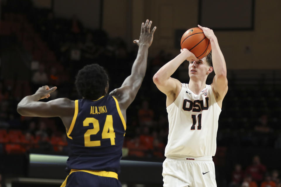 Oregon State forward Dzmitry Ryuny (11) shoots over California forward Sam Alajiki (24) during the first half of an NCAA college basketball game in Corvallis, Ore., Saturday, March 4, 2023. (AP Photo/Amanda Loman)