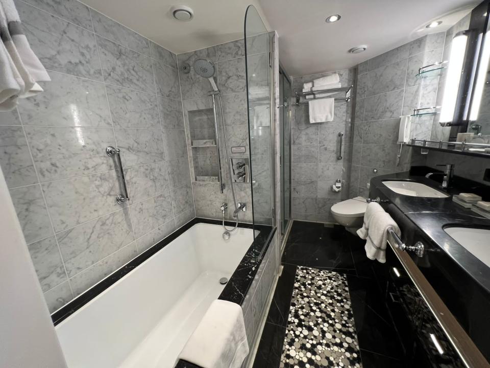 large marble shower and bathroom with tub