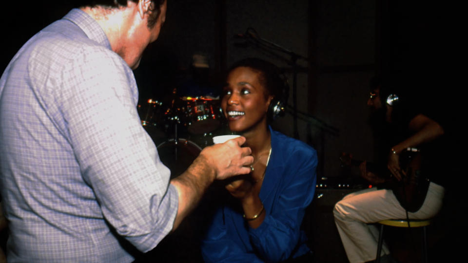 Whitney Houston smiles at her manager Gene Harvey at her CBS Records audition. 
