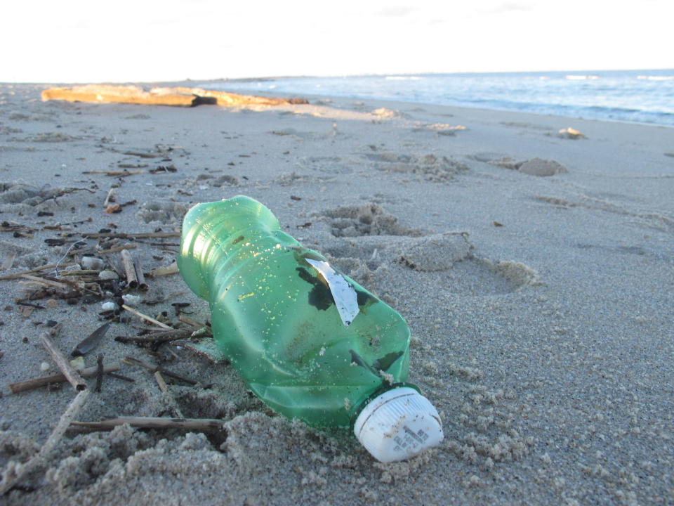 This Feb. 6, 2022 photo shows a beverage bottle on the sand in Sandy Hook, N.J. On March 30, 2022 the Clean Ocean Action environmental group said over 10,000 volunteers picked up over 513,000 pieces of trash from New Jersey's beaches last year, setting a new record. Plastic items accounted for over 82% of the total. (AP Photo/Wayne Parry)