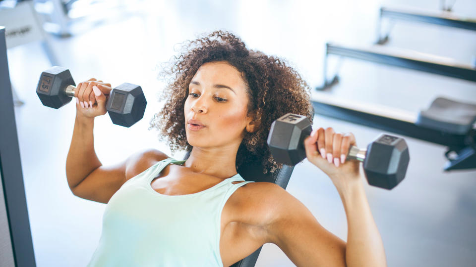 Women doing a shoulder press superset