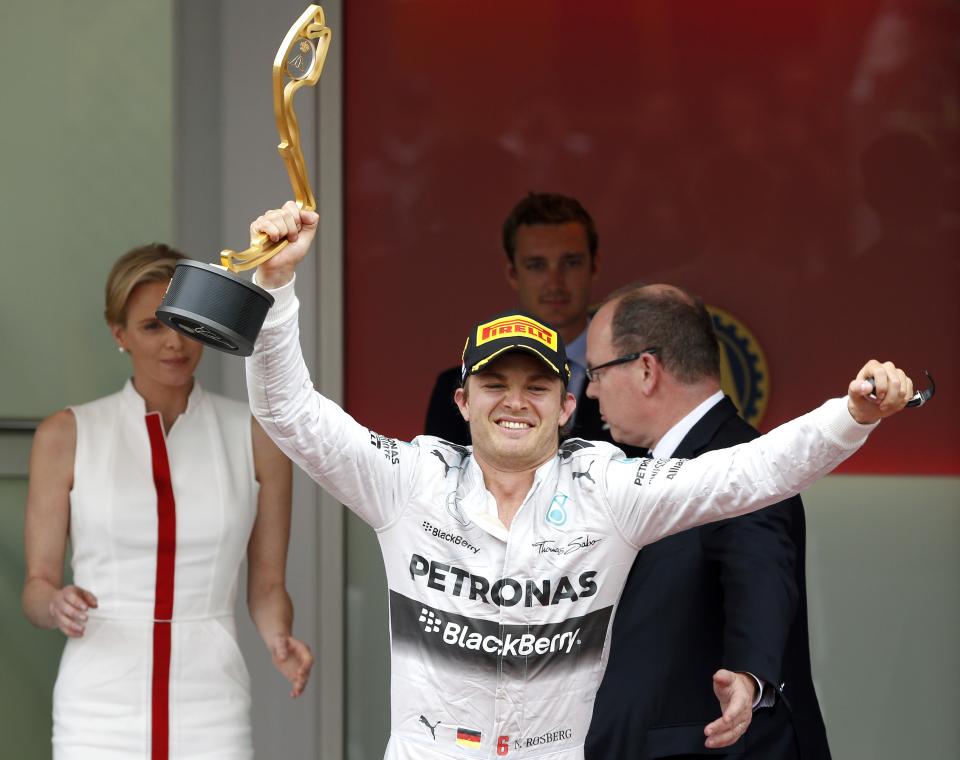 Mercedes Formula One driver Nico Rosberg of Germany celebrates on the podium with his trophy after winning the Monaco F1 Grand Prix in Monaco May 25, 2014. Rosberg won the showcase Monaco Grand Prix for the second year in a row on Sunday to snatch back the Formula One world championship lead from Mercedes team mate Lewis Hamilton. REUTERS/Stefano Rellandini (MONACO - Tags: SPORT MOTORSPORT F1)