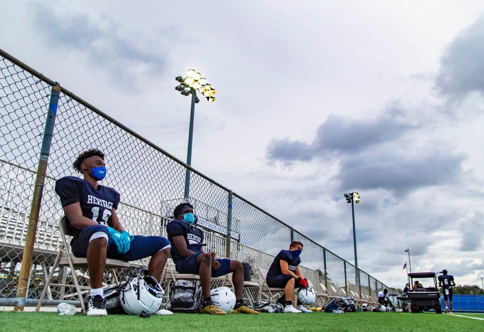 American Heritage players sit in assigned chairs during a water break in Delray Beach, September 8, 2020. Players are assigned chairs for practice and during games for social distancing. [ALLEN EYESTONE/palmbeachpost.com] 