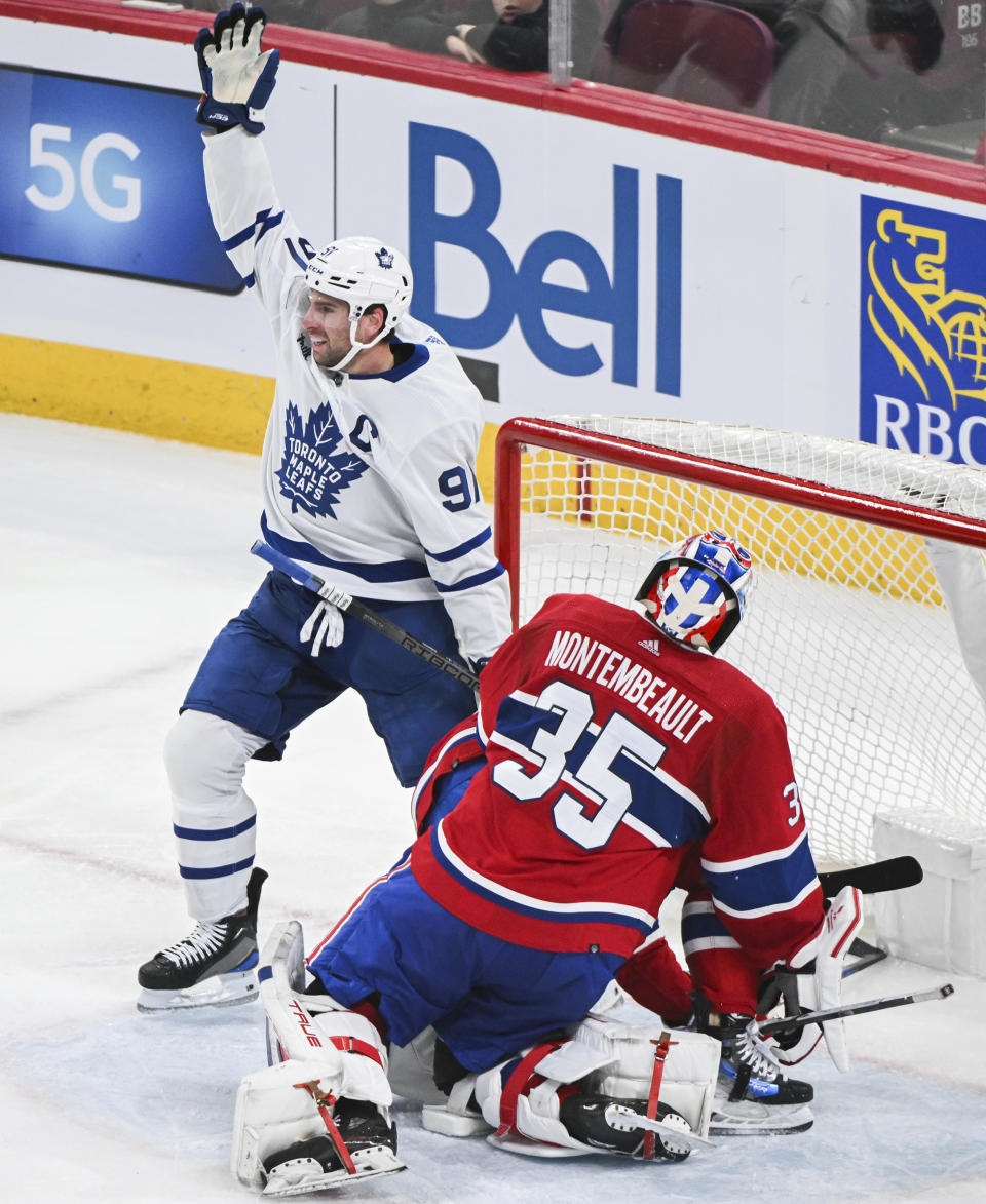 Toronto Maple Leafs' John Tavares (91) reacts after scoring against Montreal Canadiens goaltender Sam Montembeault during the third period of an NHL hockey game Saturday, March 9, 2024, in Montreal. (Graham Hughes/The Canadian Press via AP)