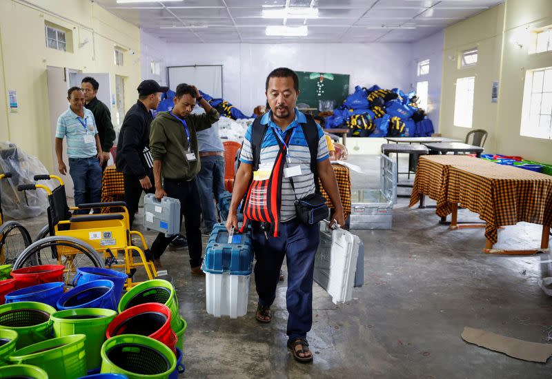 Polling officers and porters carry VVPAT and EVM to a remote village in Shillong