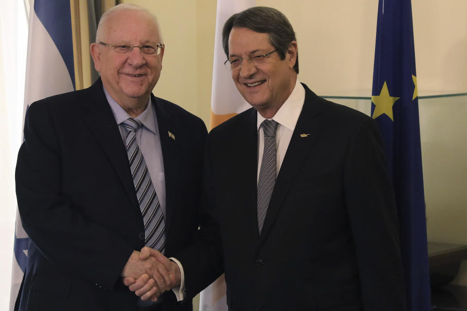 Cyprus' president Nicos Anastasiades, right, and Israel's President Reuven Rivlin shake hands during their meeting at the presidential palace in divided capital Nicosia, Cyprus, on Tuesday, Feb. 12, 2019. Rivlin is in Cyprus for one-day official visit for talks. (Yiannis Kourtoglou/Pool via AP)