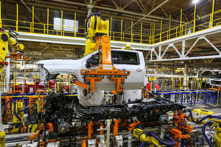 Robots swing a cab and bed into place for a new heavy duty pickup truck on the assembly line where Chevrolet Silverado trucks are being built at General Motors Flint Assembly in Flint, Michigan, U.S., January 30, 2019 John F. Martin/Chevrolet/Handout via REUTERS