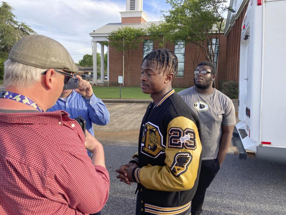 Antojuan Woody talks to reporters on Sunday, April 16, 2023, in Dadeville, Ala., about the death of Phil Dowdell, his best friend, and fellow Dadeville High School football player. Dowdell was one of several people killed in a shooting at a teenager's birthday party in the town on Saturday, April 15. (AP Photo/Jeff Amy)