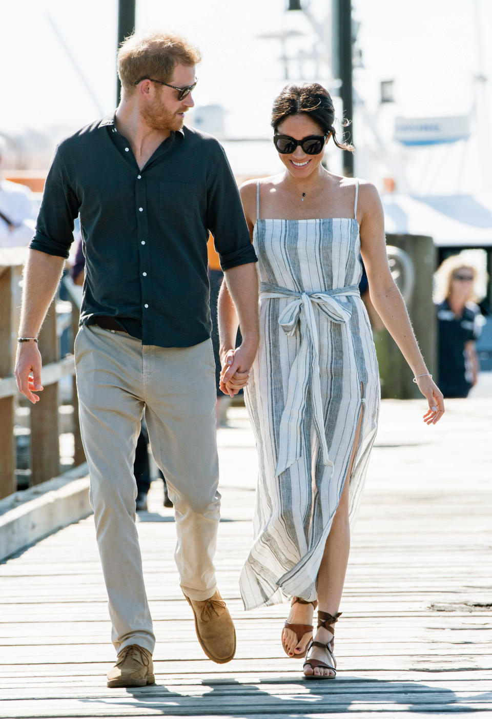 The duchess wears a striped dress by <a href="https://www.thereformation.com/products/pineapple-dress" target="_blank" rel="noopener noreferrer">Reformation</a>&nbsp;(which is currently unavailable online) on day 7 of the royal tour. The royal couple are seen walking along the Kingfisher Bay Jetty on Fraser Island on Oct. 22.