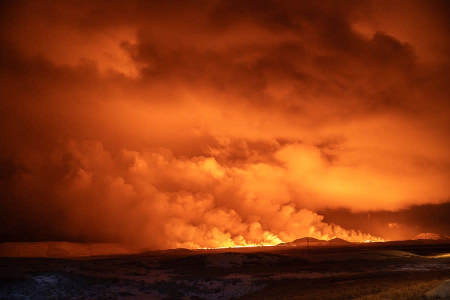 The night sky is illuminated caused by the eruption of a volcano in Grindavik on Iceland’s Reykjanes Peninsula, Monday, Dec. 18, 2023. (AP Photo/Marco Di Marco)