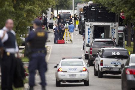 Police work in the U.S. Navy Yard after a shooting in Washington September 16, 2013. REUTERS/Joshua Roberts