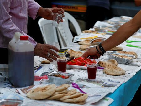 Egyptian Coptic Christians set up table with food and drinks to serve to their Muslim neighbours during Ramadan in Cairo, Egypt June 18, 2017. Picture taken June 18, 2017. REUTERS/Mohamed Abd El Ghany