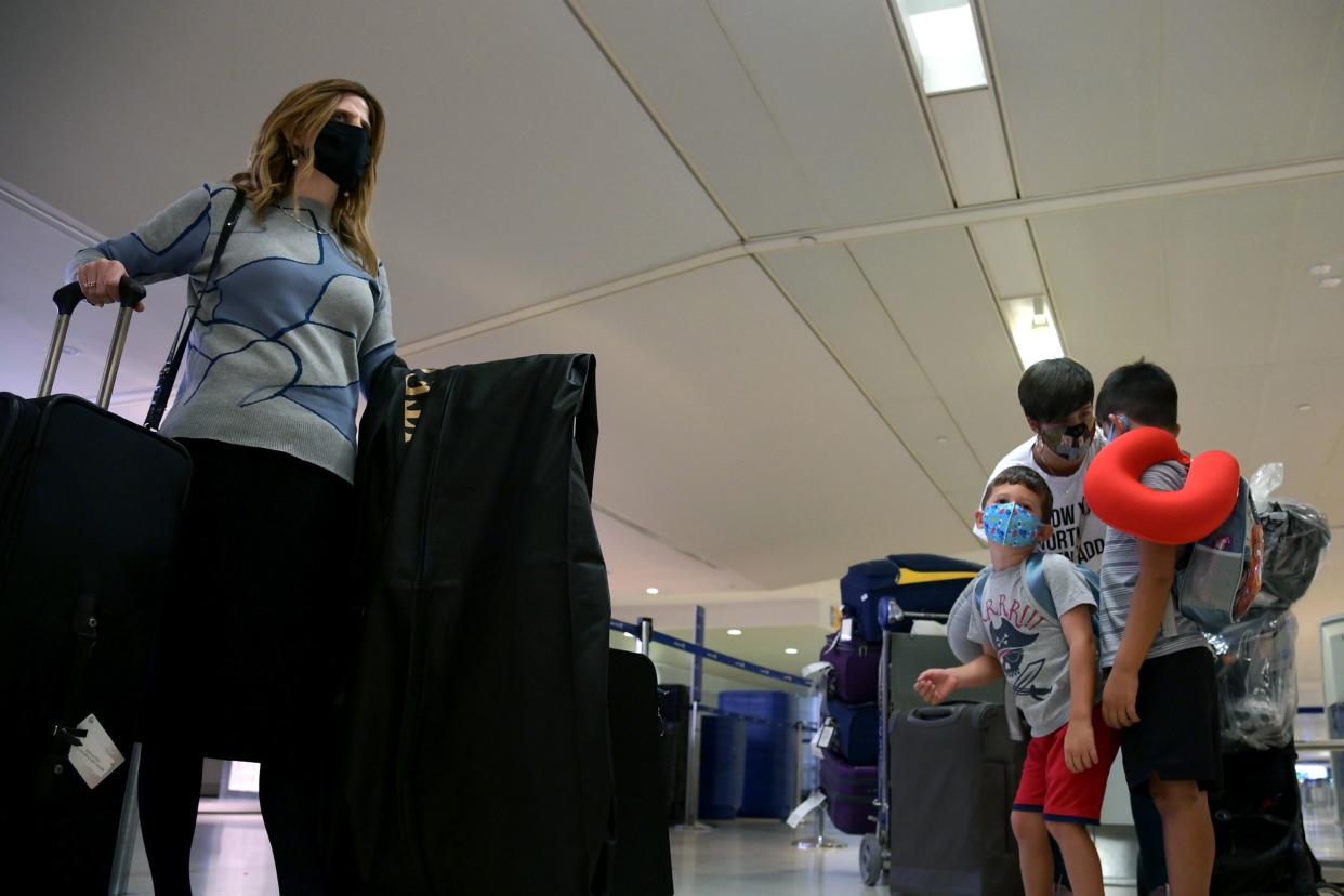 Air travelers check in for their flights at Newark Liberty International Airport on Oct. 22, 2020 in Newark, New Jersey.