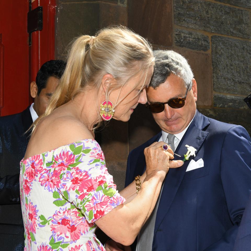 Gigi Mortimer pinning the boutonniere on her husband, Avie, who was Topper’s best man.