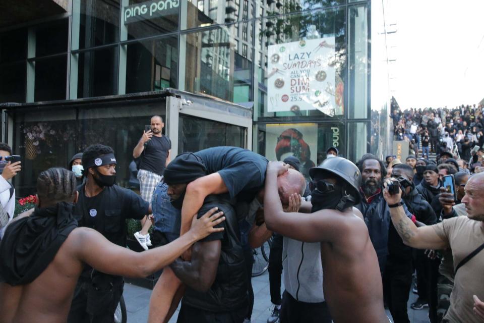 A group of men help an injured man away after he was attacked on Saturday (Getty Images)