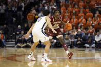 Boston College's Chas Kelley III (00) takes the ball up the court against Virginia's Kihei Clark (0) during the first half of an NCAA college basketball game in Charlottesville, Va., Saturday, Jan. 28, 2023. (AP Photo/Mike Kropf)