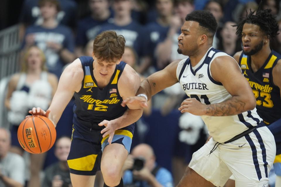 Marquette's Ben Gold (12) makes a steal against Butler's Pierre Brooks (21) during the second half of an NCAA college basketball game Tuesday, Feb. 13, 2024, in Indianapolis. (AP Photo/Darron Cummings)